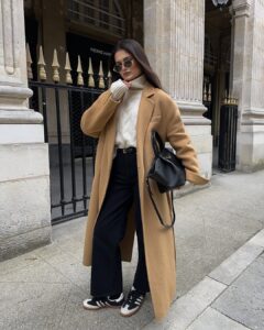 Chic Parisian Layers: Camel Coat with Cozy Turtleneck and Sneakers