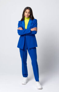Business Women Attire: Woman in stylish blue suit and green knitwear